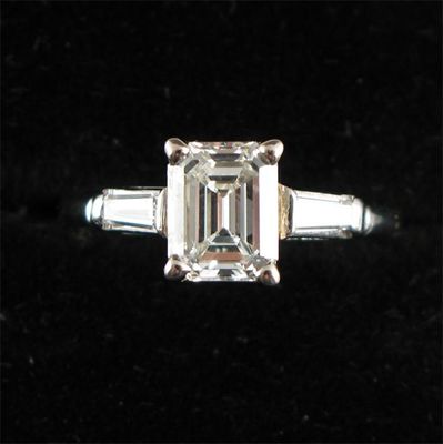 Appraisal: A diamond solitaire ring The emerald cut diamond weighs approximately