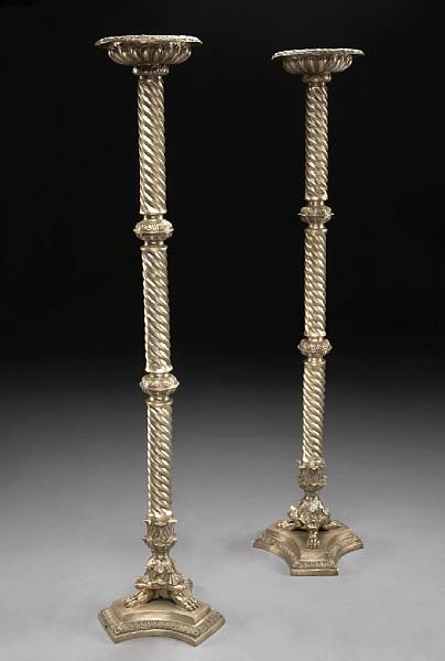 Appraisal: A pair of Pompeiian style silvered bronze torch res Each