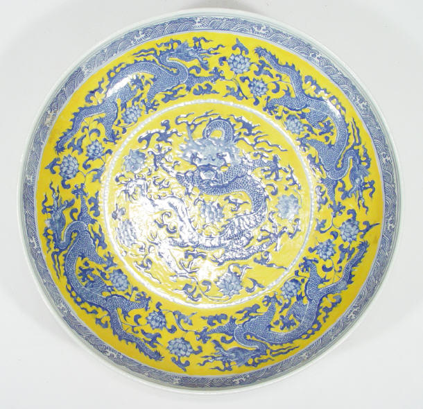 Appraisal: Large Chinese porcelain shallow bowl decorated with blue dragons onto