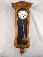 Appraisal: A continental pendulum wall clock in glazed carved case with