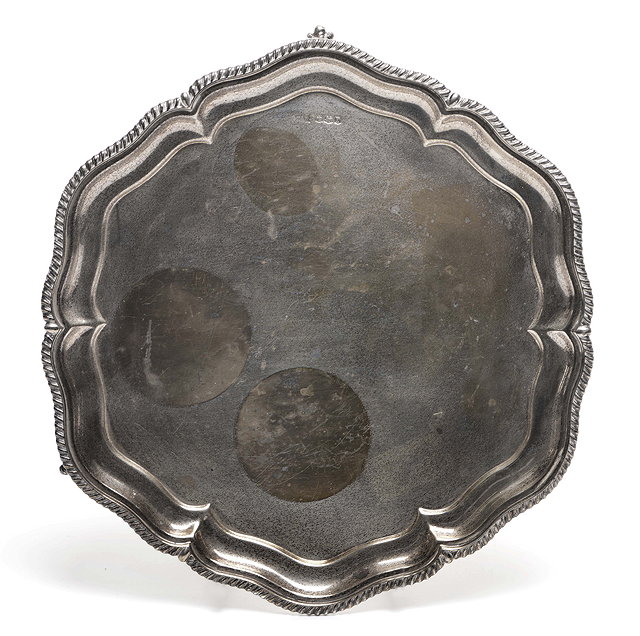 Appraisal: A HEXAGONAL SILVER SALVER with serpentine gadrooned edge and standing