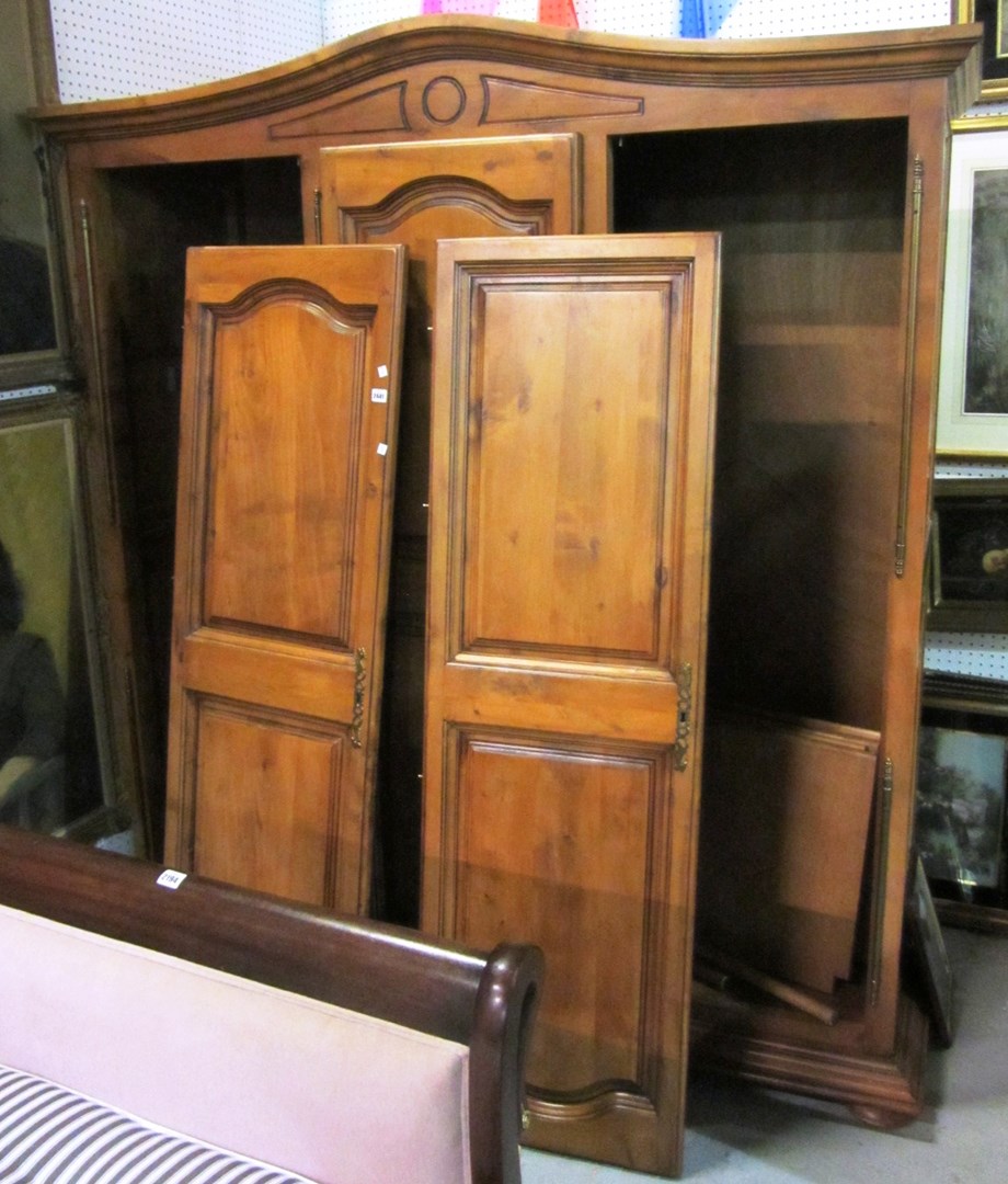 Appraisal: A th century walnut triple wardrobe