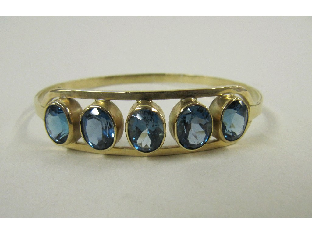 Appraisal: Nine carat gold blue topaz set bangle