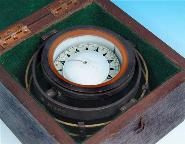 Appraisal: A GIMBAL MOUNTED DRY-CARD COMPASS unsigned but numbered in fitted