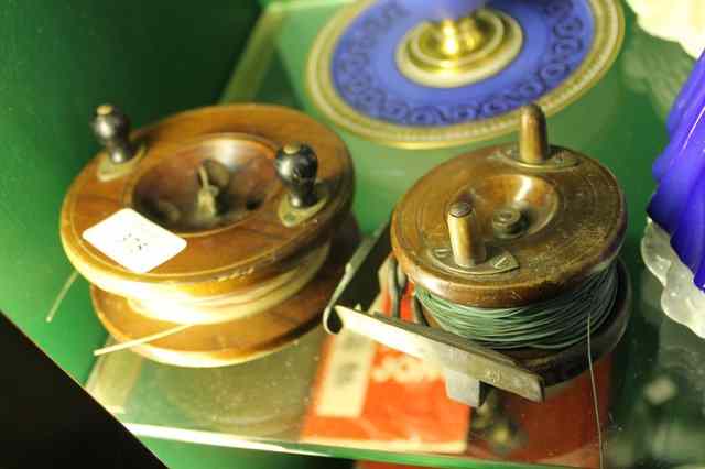 Appraisal: EDWARDIAN FLY FISHING REELS one marked etonsun