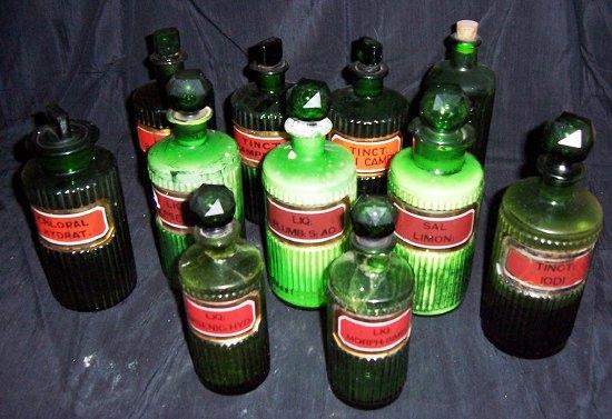 Appraisal: A collection of green glass drug jars and stoppers various