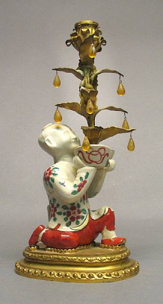 Appraisal: A Japanese style glazed ceramic figure of a kneeling Chinese