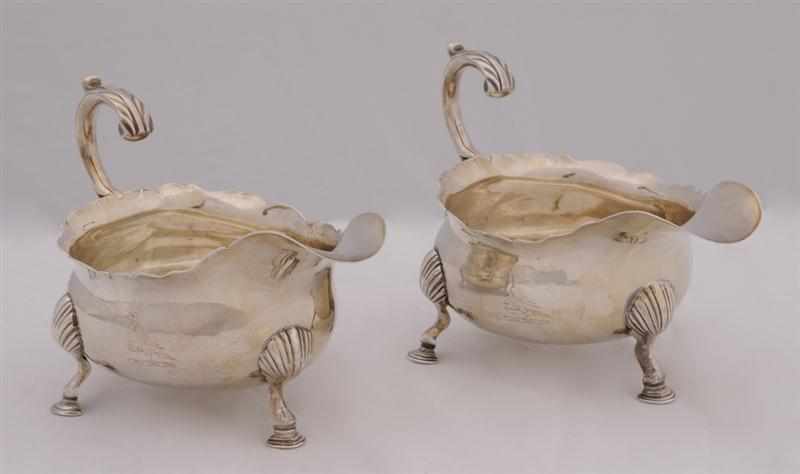 Appraisal: PAIR OF GEORGE II CRESTED SILVER TRIPOD SAUCE BOATS Maker's