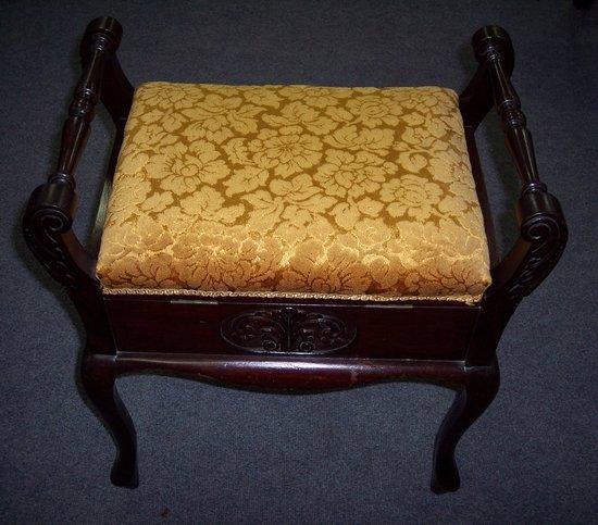 Appraisal: A Victorian mahogany piano stool with upholstered rising seat compartments