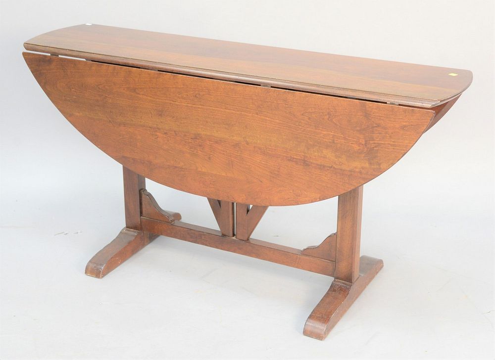 Appraisal: Cherry drop-leaf table with tressel base ht top x open