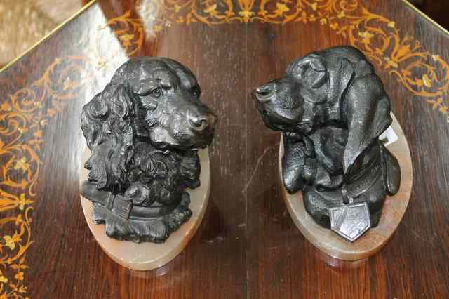 Appraisal: A PAIR OF BRONZED CAST SCULPTURES OF DOGS after Lecourtier