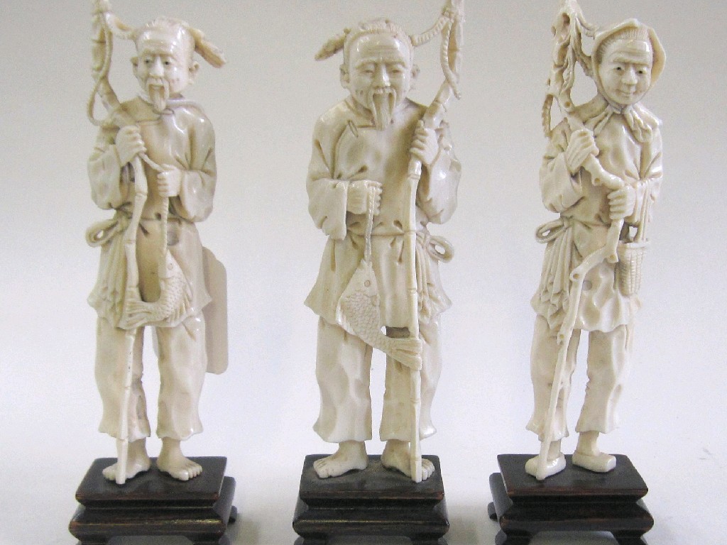 Appraisal: Lot comprising three carved ivory figures