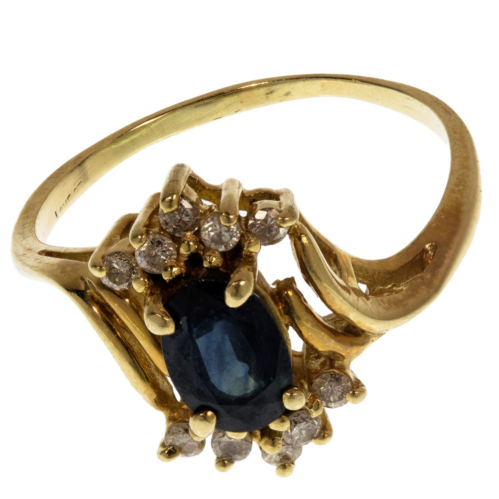 Appraisal: K YELLOW GOLD SAPPHIRE AND DIAMOND RINGOval cut sapphire flanked