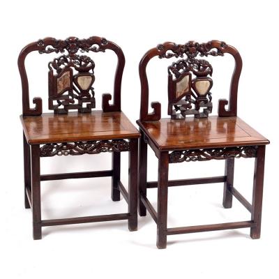 Appraisal: A pair of Chinese hardwood chairs the carved pierced splats