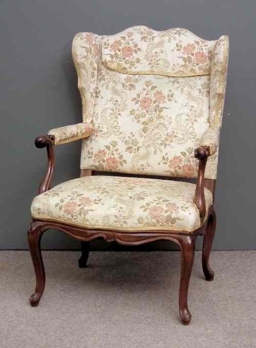 Appraisal: A Continental mahogany framed wing back library armchair the shaped