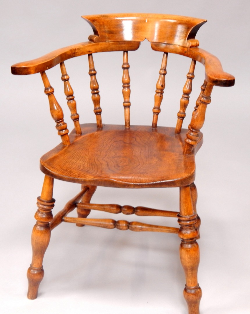 Appraisal: A Victorian oak and elm smoker's bow chair raised on