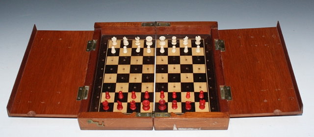 Appraisal: A STAINED BONE TRAVELLING CHESS SET in a folding mahogany