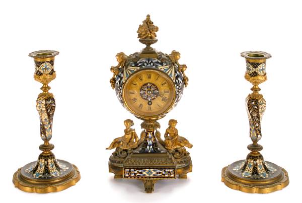 Appraisal: A champlev enamel and gilt bronze clock garniture comprising a