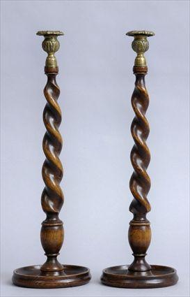 Appraisal: PAIR OF ENGLISH OAK SPIRAL TWIST TABLE CANDLESTICKS WITH BRASS