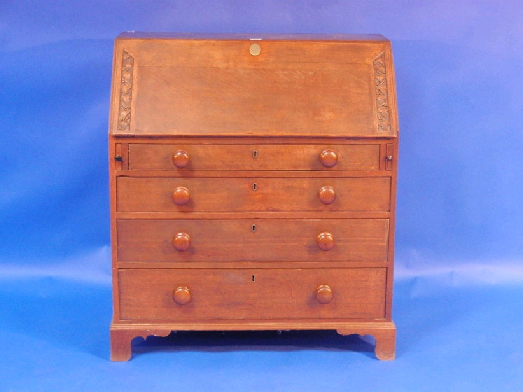 Appraisal: A Georgian oak bureau with carved fall flap revealing a