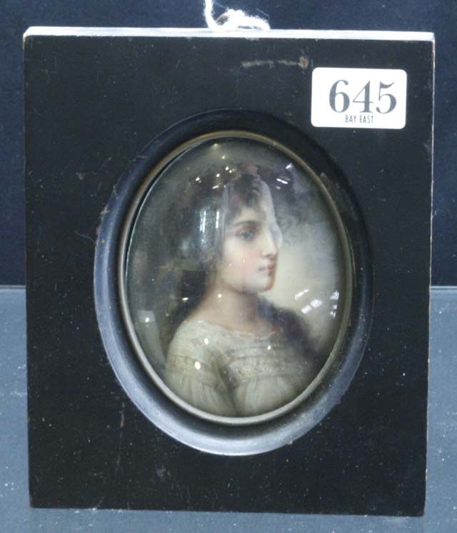 Appraisal: An oval miniature of a young woman in profile on