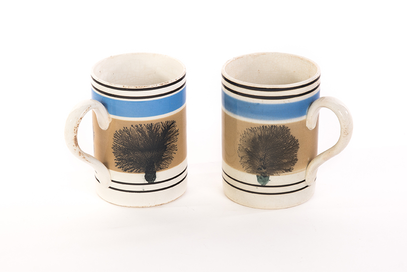 Appraisal: PAIR OF MOCHA MUGS Mid th century Blue brown and