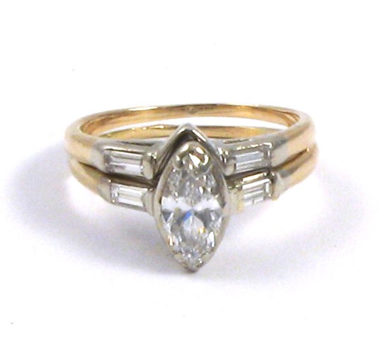 Appraisal: DIAMOND AND FOURTEEN KARAT GOLD RING centering a marquise-cut diamond