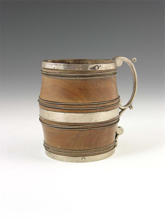 Appraisal: A European turned lignum vitae and metal mounted mug