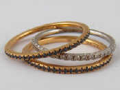 Appraisal: Three carat gold eternity rings two yellow gold and sapphire