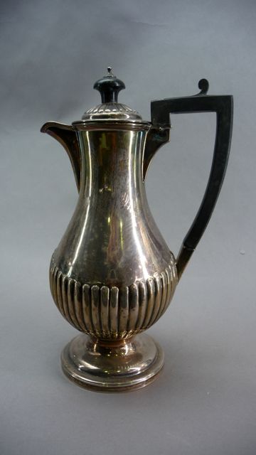 Appraisal: A Victorian silver coffee pot of baluster form with half