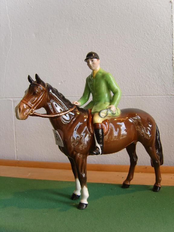 Appraisal: A Beswick model of a green jacketed huntsman seated on