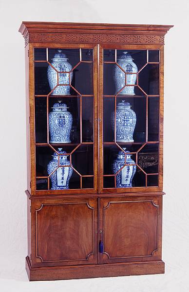 Appraisal: A George III style mahogany bookcase cabinet The crest carved