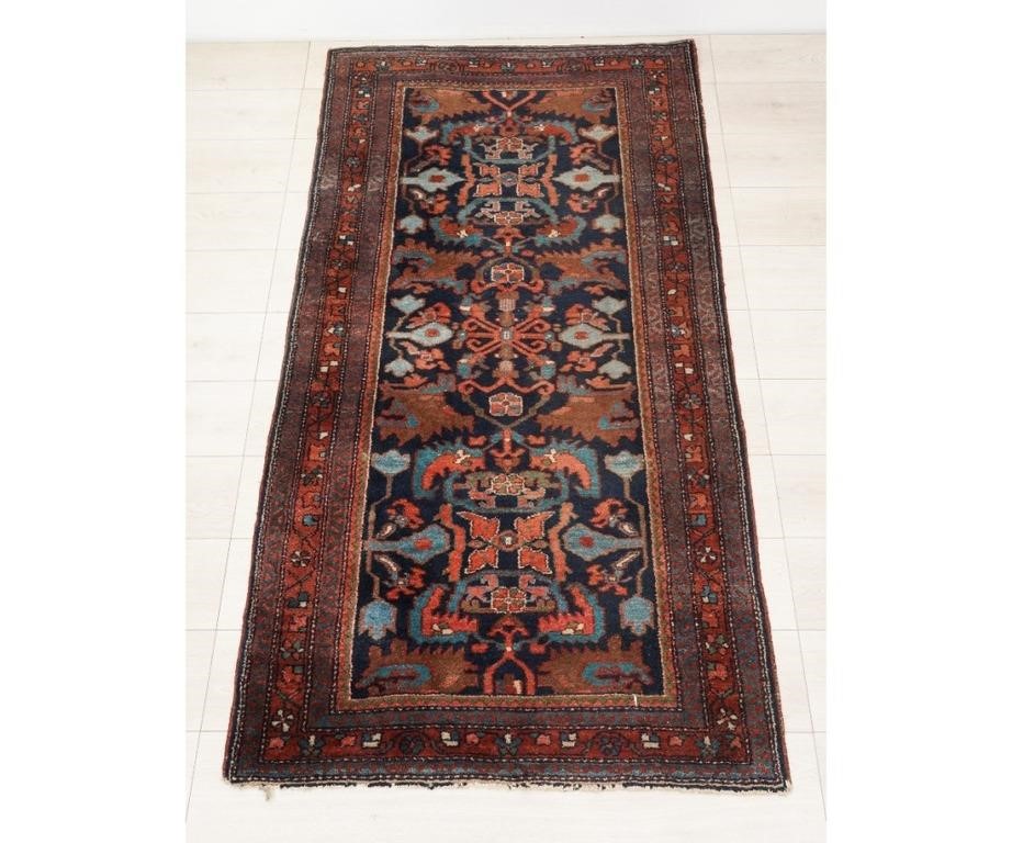 Appraisal: Hamadan hall carpet with floral patterns and blue field '