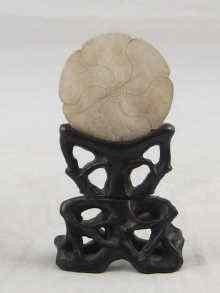 Appraisal: A Chinese jade disc carved as a six petal flower