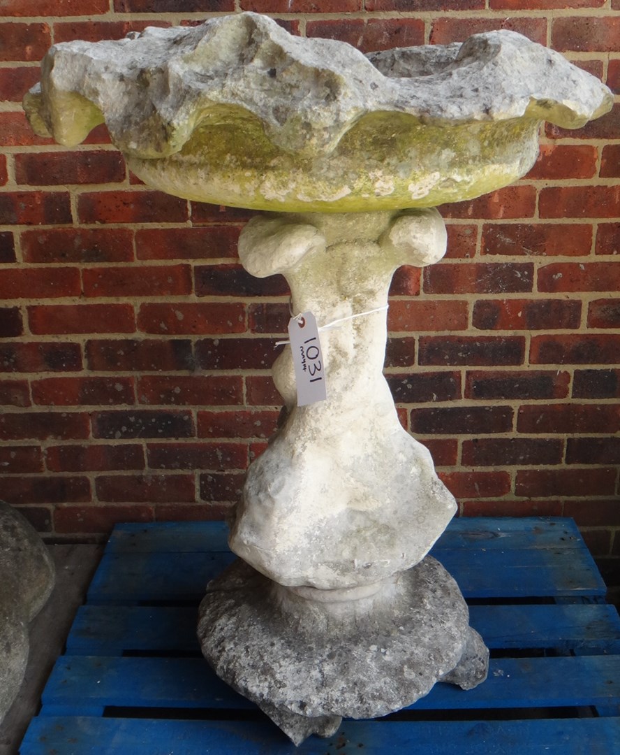 Appraisal: A carved limestone water fountain the shaped circular bowl on