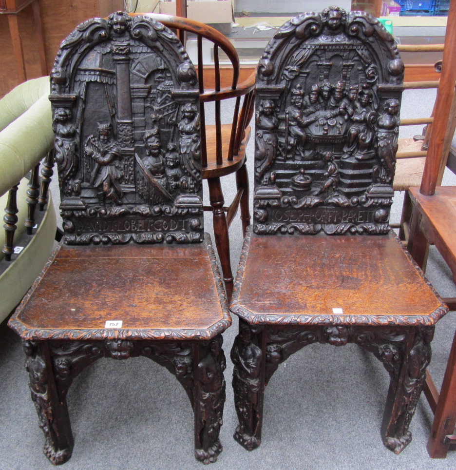 Appraisal: A pair of Victorian oak hall chairs with profusely carved