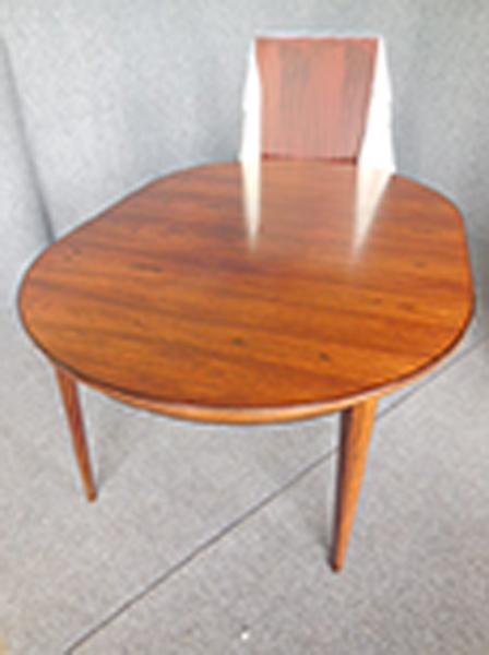 Appraisal: DANISH OMAN JUNIOR ROSEWOOD THREE-LEAF EXTENSION TABLE diameter unextended