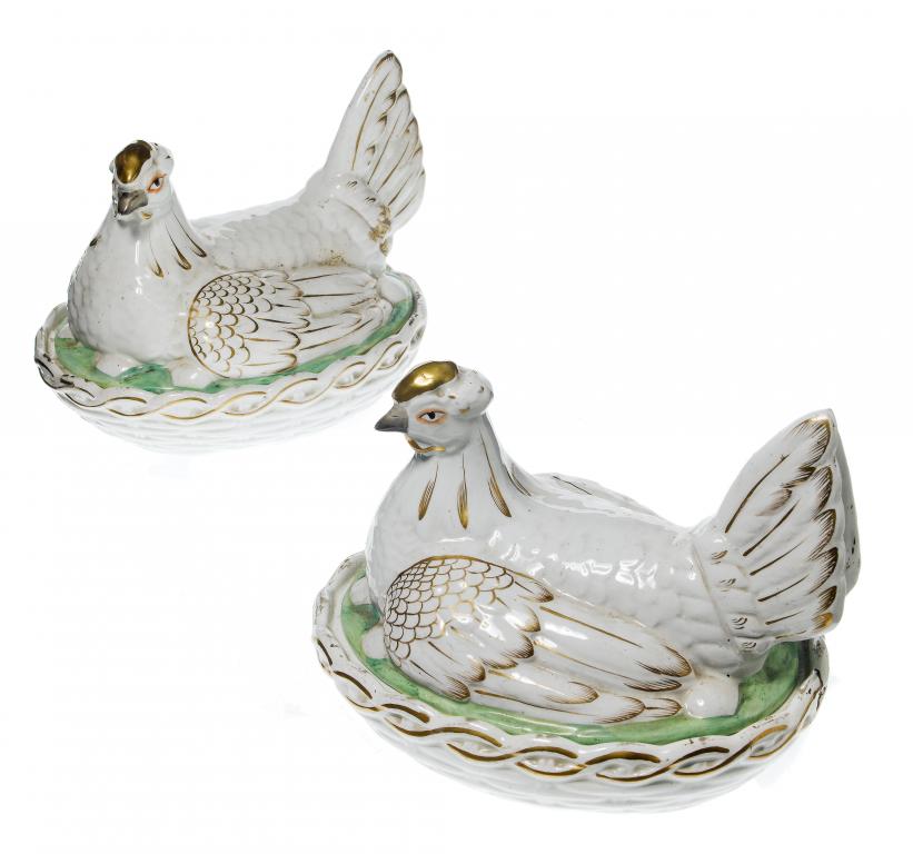 Appraisal: A PAIR OF STAFFORDSHIRE WHITE EARTHENWARE SITTING HEN EGG BASKETS