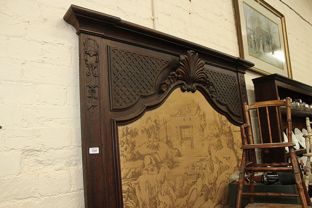 Appraisal: A BELGIAN DARK OAK TRUMEAU MIRROR with blind fretwork decoration