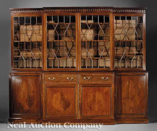 Appraisal: An Antique Georgian-Style Mahogany Breakfront Bookcase th c Gothicized cornice