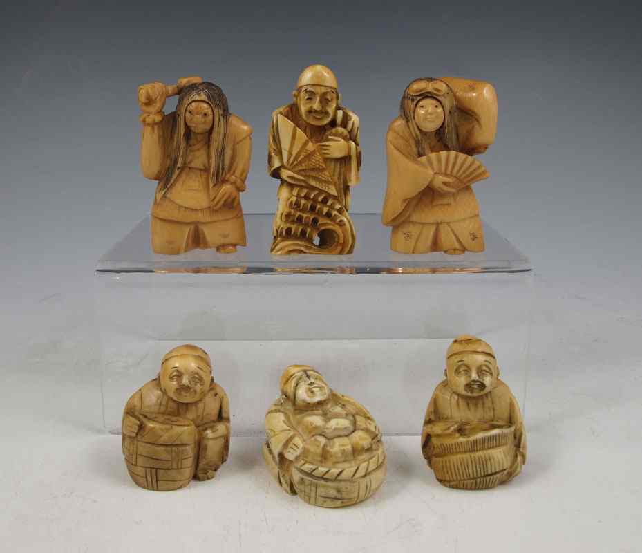 Appraisal: JAPANESE CARVED IVORY NETSUKE To include Man with hatchet articulated