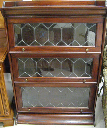 Appraisal: A MAHOGANY STACKING BOOKCASE having three horizontal sections each with