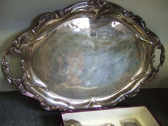 Appraisal: A plated shaped oval twin handled tray decorated with an