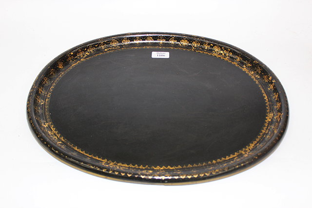 Appraisal: A VICTORIAN OVAL BLACK LACQUERED PAPIER MACHE TRAY with gilt