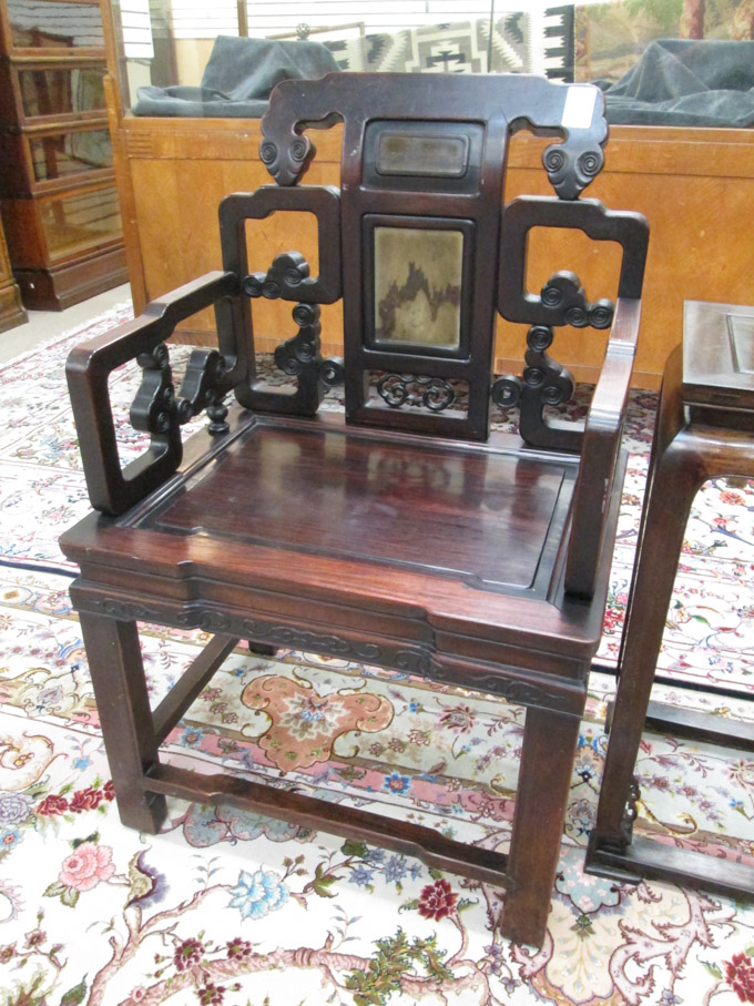 Appraisal: CHINESE CARVED ROSEWOOD ARMCHAIR having a pierced scrollwork back and