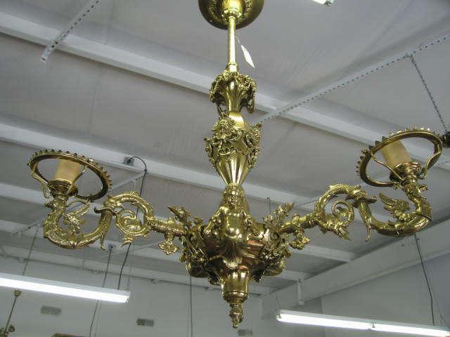 Appraisal: Victorian Brass Chandelier Art Nouveau with cherubs faces dolphins and