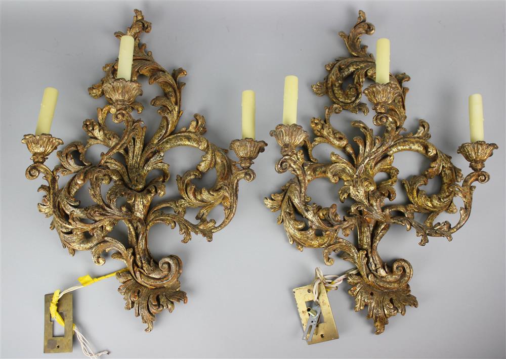 Appraisal: PAIR OF ROCOCO STYLE GILTWOOD THREE-LIGHT WALL SCONCES each having