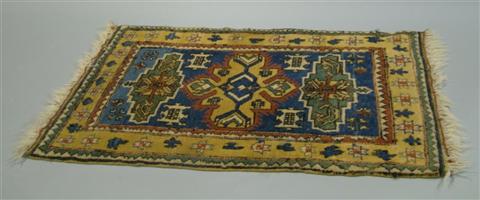 Appraisal: ORIENTAL STYLE MUSTARD AND NAVY GROUND RUG x INCHES