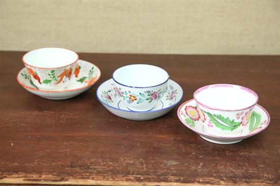 Appraisal: THREE HANDELESS CUPS AND SAUCERS Two pearlware with handpainted flowers