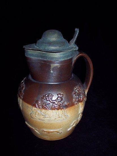 Appraisal: A mid th Century brown glaze jug with hunting scenes